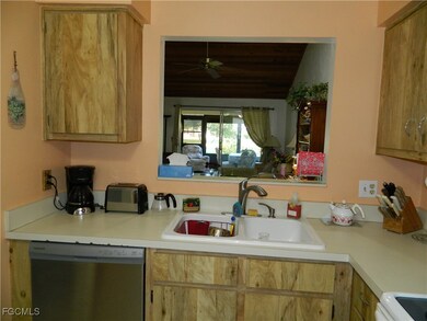 Kitchen featuring dishwasher, light countertops, light brown cabinetry, and range with electric cooktop