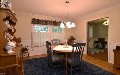 Dining room with ornamental molding and light hard