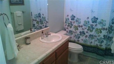 Main Bathroom with tile floor and counter top vani