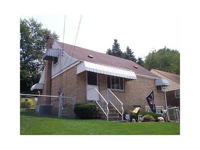 Exterior Front. Concrete walkways lead you to the front door.  Note that it has a chain link fence that  encloses the entire back yards.  There is a gate on both sides of the home so you can gain entry.