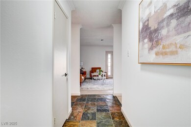 Corridor with stone finish floor, baseboards, and