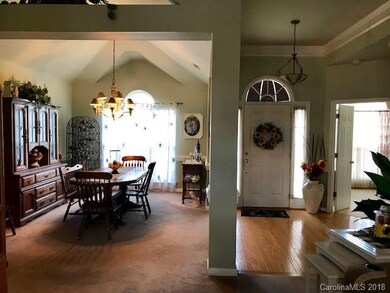 Hardwood floor entry leads into open floorplan of 