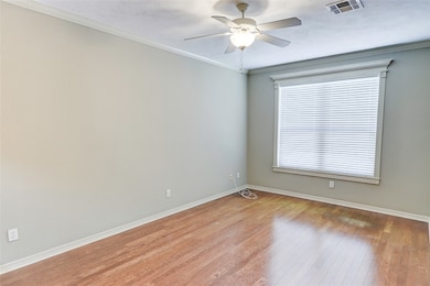 Empty room with light wood-type flooring, a ceilin