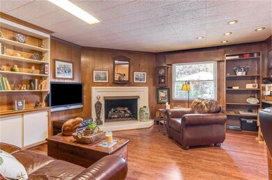 Den has corner fireplace with gas logs.