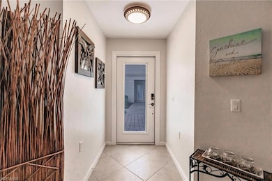 Interior mini-blind door opens to tiled entryway.