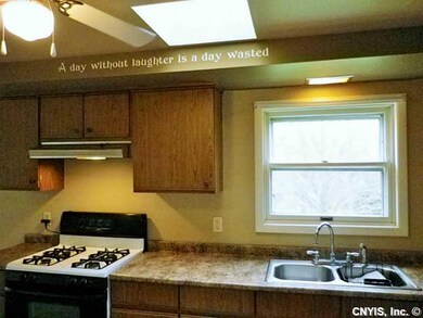 Kitchen. Natural light streams through skylight.Pl