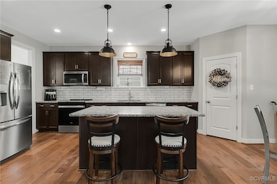 Kitchen featuring pendant lighting, appliances wit
