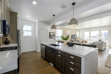 A total 'wow' kitchen-quartz countertops, stainless appliances, and a big island for charcuterie or homework.*Model Home