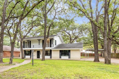 View of front of house featuring a front yard, a porch, and a carport