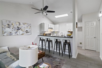 Kitchen featuring stainless steel range, white cab