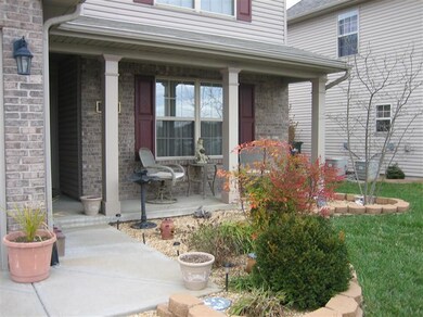 View of covered front porch. Landscapin