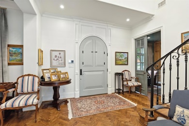 Entrance foyer featuring dark parquet flooring and