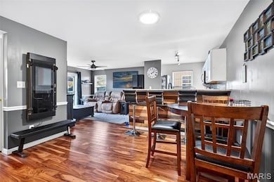 Dining area featuring wood finished floors and a ceiling fan
