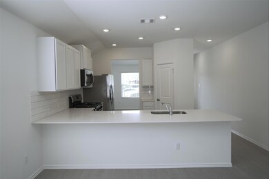 Kitchen with tasteful backsplash, stainless steel
