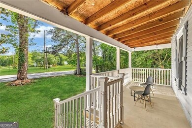 Porch featuring a lawn