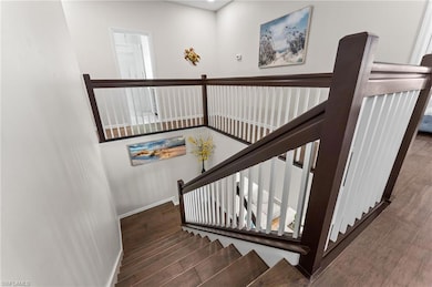 Painted Staircase with Spindles and Tile Wood Floo