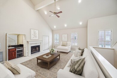 The living room features soaring double-height cei