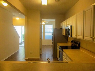 Kitchen featuring appliances with stainless steel finishes, dark wood-style floors, light countertops, and ceiling fan