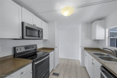 Kitchen with stainless steel appliances, sink, whi