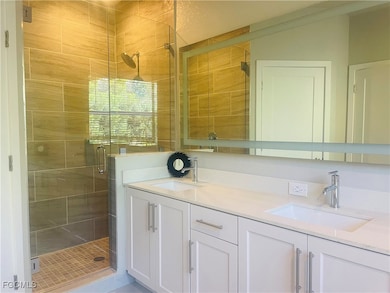 Bathroom with a shower stall and double vanity