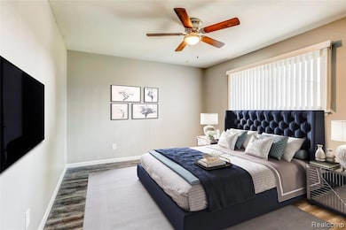 Bedroom featuring wood finished floors and a ceiling fan