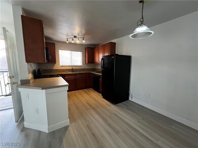 Kitchen featuring dark countertops, hanging light