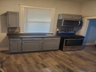 Kitchen featuring gray cabinetry, stainless steel 