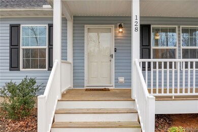 View of exterior entry featuring covered porch