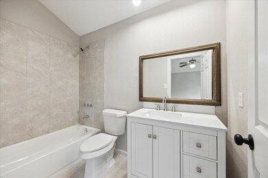 Full bath featuring toilet,  shower combination, 