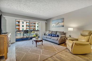 Living room with a textured ceiling and wood finis