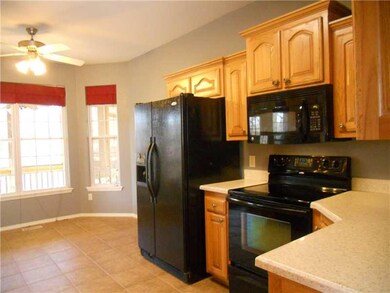 Exterior Front. Kitchen features striking black appliances and solid surface counters.  Refrigerator is included!