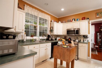 Kitchen featuring decorative backsplash, light woo