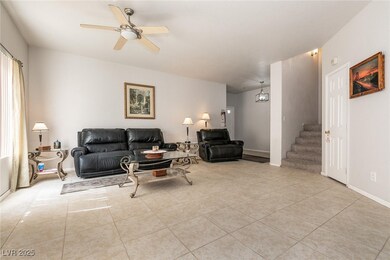 Living area with stairway, tile patterned flooring