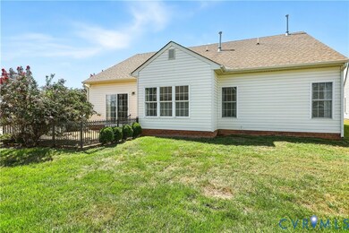 Back of property with roof with shingles and a wooden deck