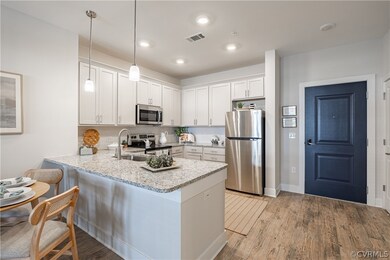 Kitchen with hanging light fixtures, stainless ste