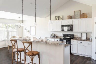 Kitchen featuring a breakfast bar, black appliance