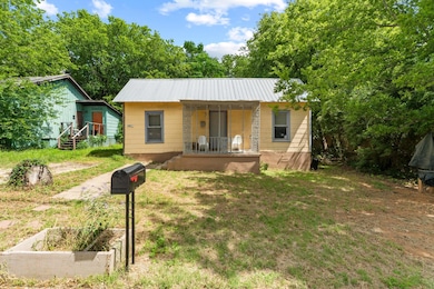 Bungalow-style home featuring a porch, metal roof