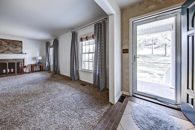 Front entry looking into the living room with a fireplace.