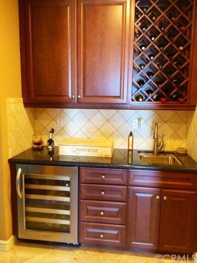 High-end wine fridge next to a classic wine rack. 