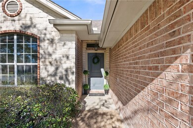 Property entrance with stone siding and brick siding