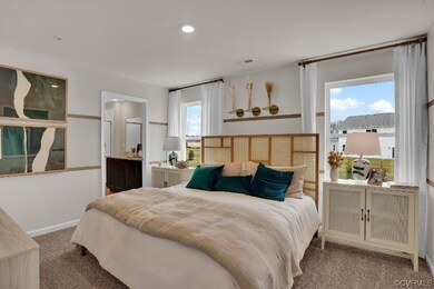 Bedroom with multiple windows, carpet floors, and