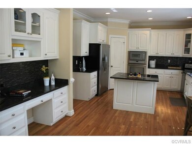 Built in desk and hardwood flooring just a few spe