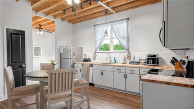 Kitchen featuring butcher block countertops, a sin