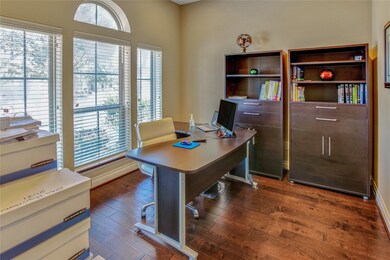 Study/Home Office at entry of home. Beautiful wood flooring with wall of windows for light and bright days.