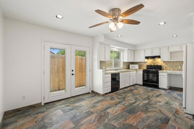 Kitchen featuring french doors, tile countertops,
