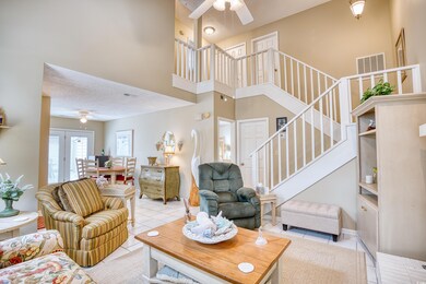 Tiled living room with a high ceiling, ceiling fan
