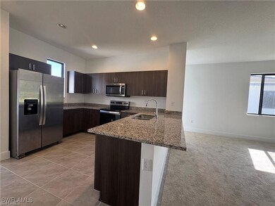 Kitchen with stainless steel appliances, a sink, a