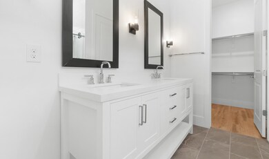Primary bath features freestanding vanity with dual sinks