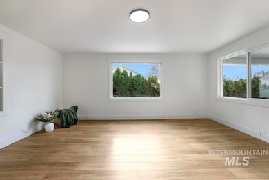 Unfurnished room featuring light wood-style floors and baseboards