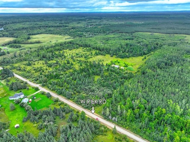 Aerial view of property's location with a heavily wooded area
